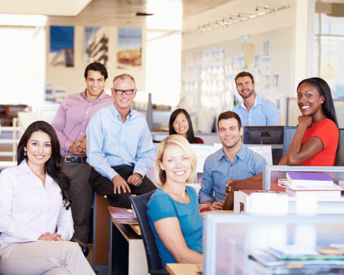 a group of Nevada business employees sitting at their desks after implementing new hr solution
