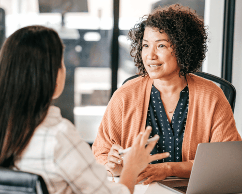 two women talking about HR services offered in the office of Nevada business
