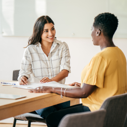 two people sitting at the desk and working on hr solutions and services for small business in Nevada
