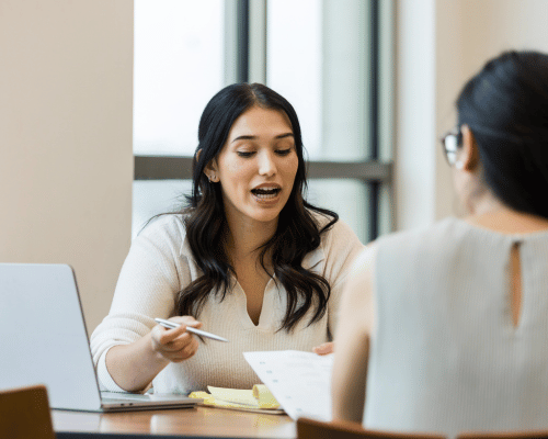 a woman showing hr solutions and services to a small business owner in Nevada
