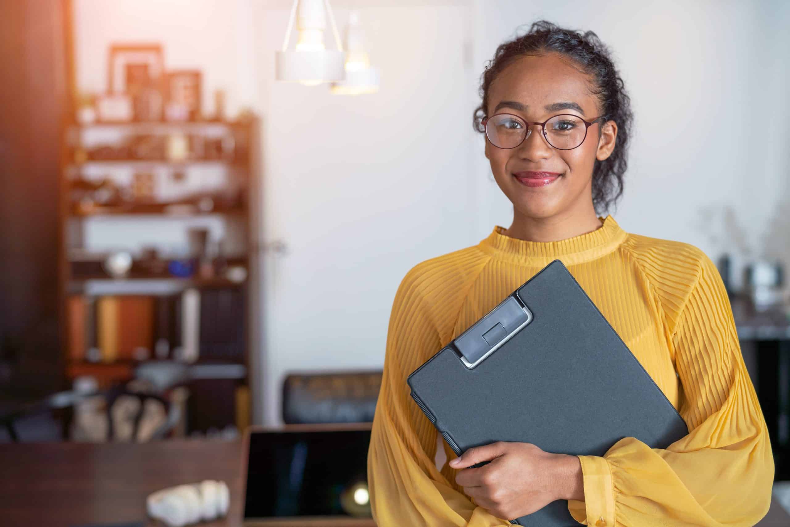 a woman with a clipboard at Nevada business office after discussing hr services and solutions
